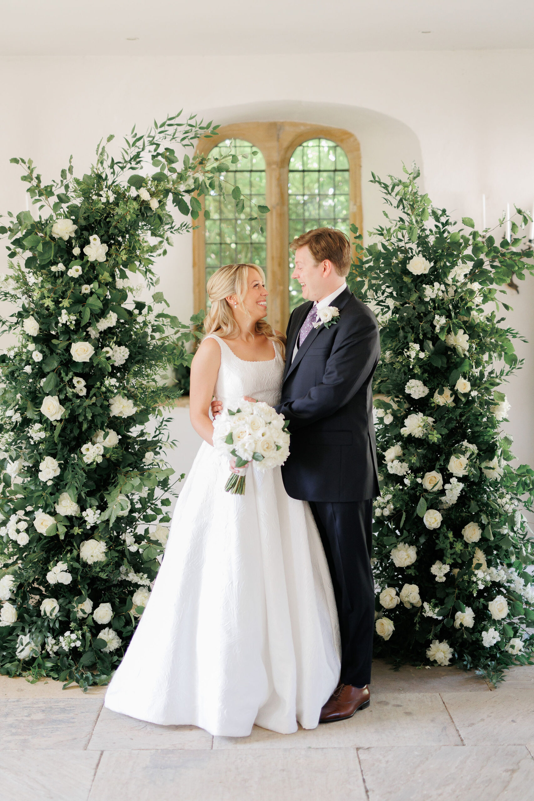 Brympton House wedding florist Flourish and Grace with White Stag Weddings Photography ceremony arch with foliage and white flowers