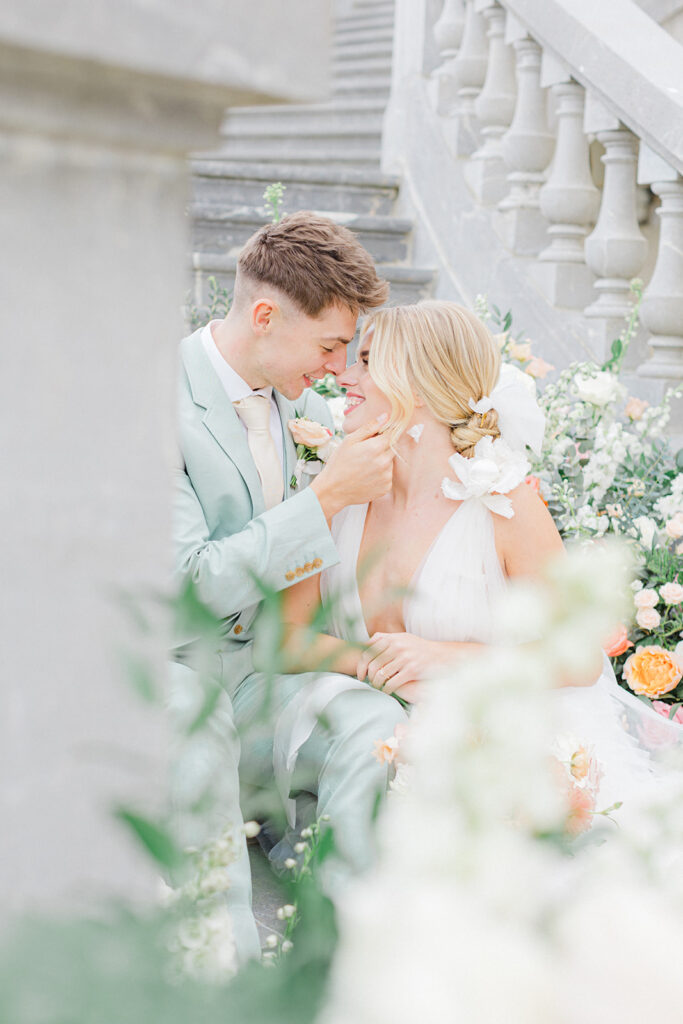 Peach Fuzz Pantone Colour of the Year Wedding flowers luxury florist Flourish and Grace photography by Natalie Stevenson in Paris at Chateau Bouffemont. Flower urns and meadows on steps