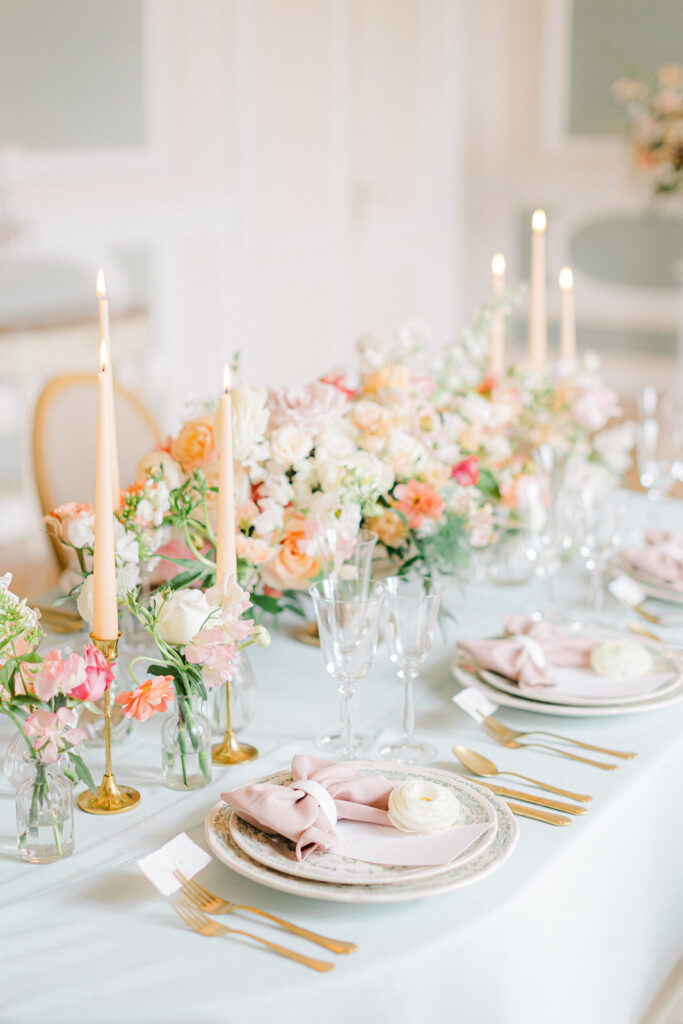 Peach Fuzz Pantone Colour of the Year Wedding flowers luxury florist Flourish and Grace photography by Natalie Stevenson in Paris at Chateau Bouffemont. Flower urns and table flowers in ballroom