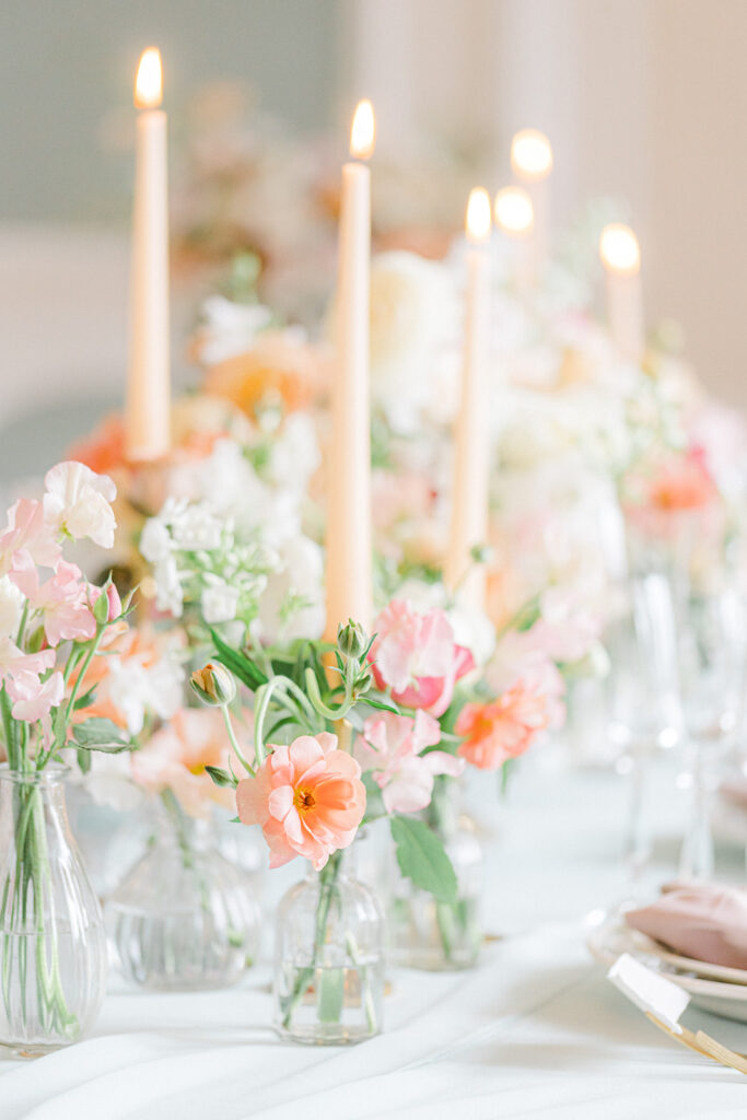 Peach Fuzz Pantone Colour of the Year Wedding flowers luxury florist Flourish and Grace photography by Natalie Stevenson in Paris at Chateau Bouffemont. Flower urns and table flowers in ballroom