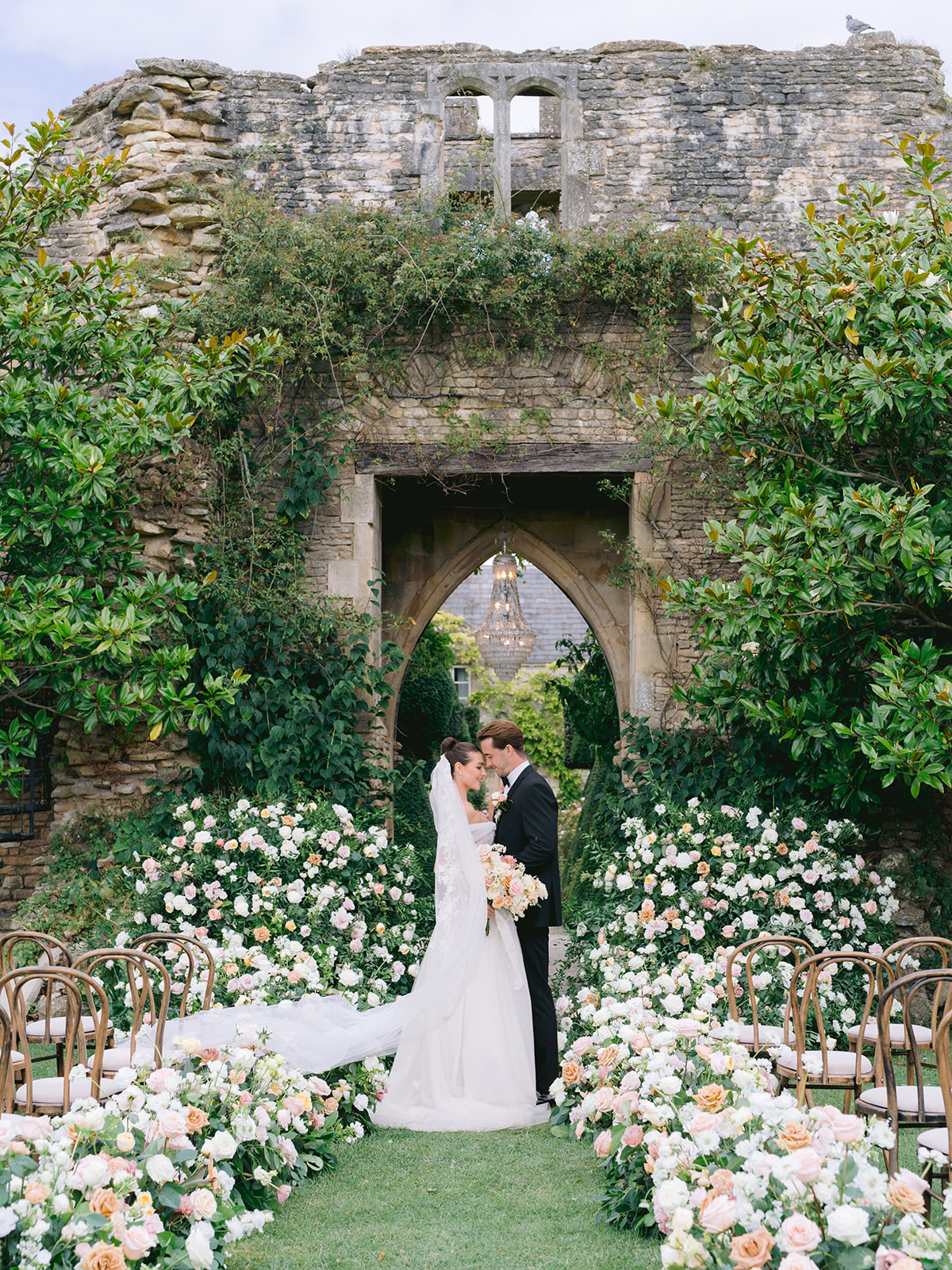 Luxury wedding at Euridge Manor with flowers along the aisle by florist Flourish and Grace