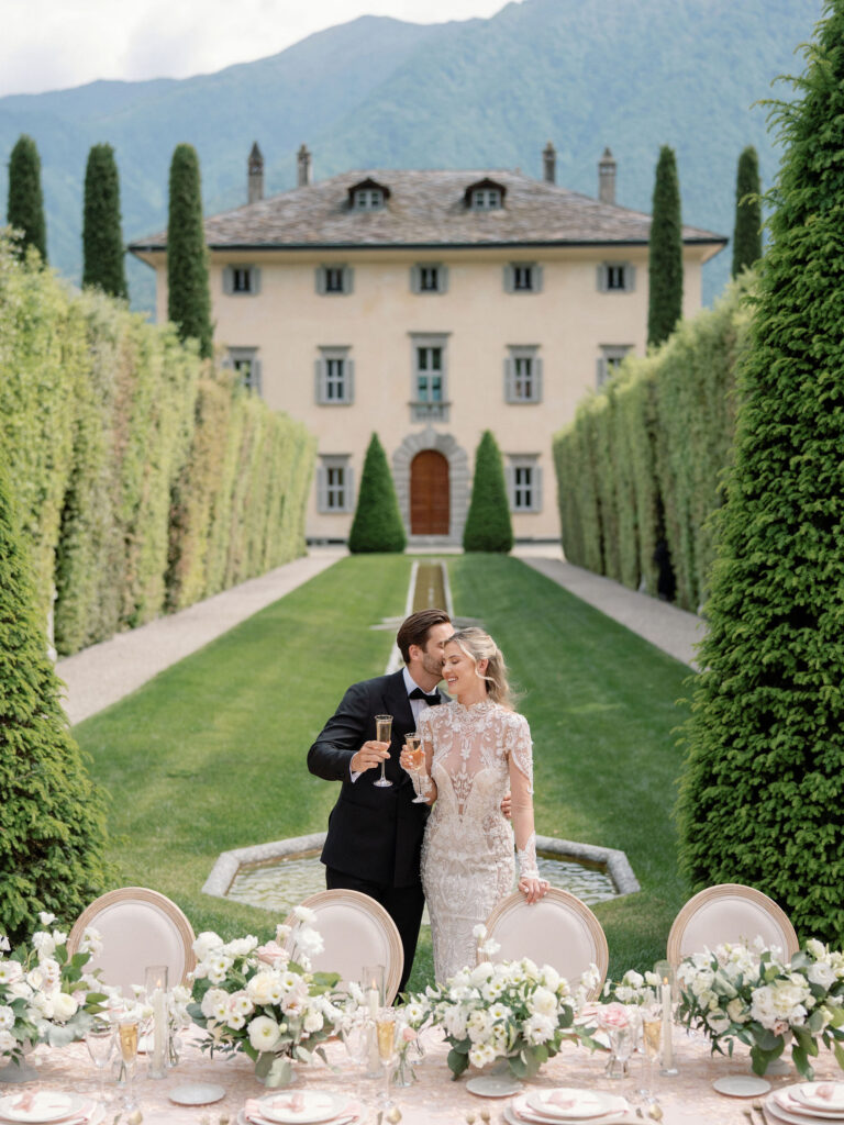 Bride and groom at luxury destination wedding at Villa Balbiano, Lake Como with table flowers by flourish and grace