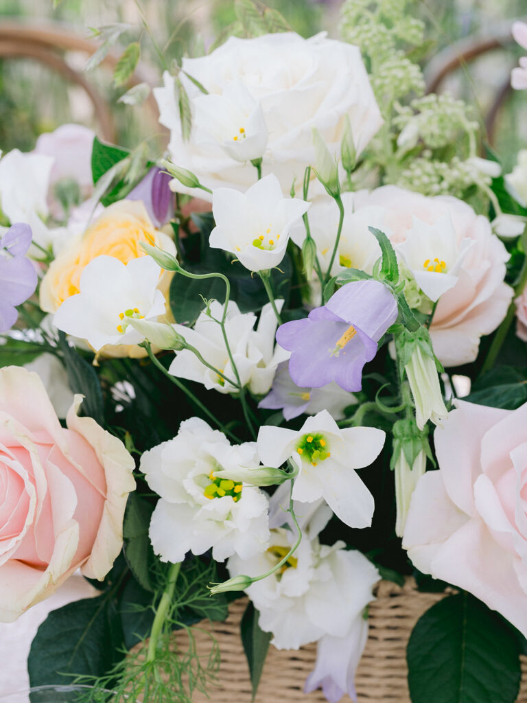 The colour palette was an important part of creating that sense of romance. Rather than using a single shade of pink, we layered several subtle tones together: shell pink, blush and peach alongside ivory, lilac and lavender, with occasional yellow flowers bringing a little warmth and brightness. Roses and spray roses gave the arrangements their romantic foundation, while delphiniums, lisianthus and scabiosa introduced height and delicacy. Grasses, trailing vines and abundant foliage softened everything further, creating the loose, garden-inspired movement that ran throughout the designs. The result felt colourful without becoming overly bright, and whimsical without losing the elegance of the setting.